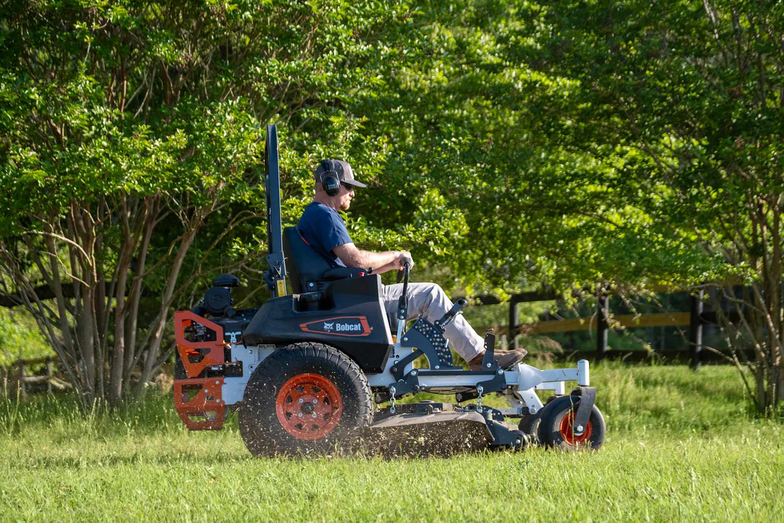 Operator mowing a commercial property with a Bobcat ZT7000 zero-turn mower